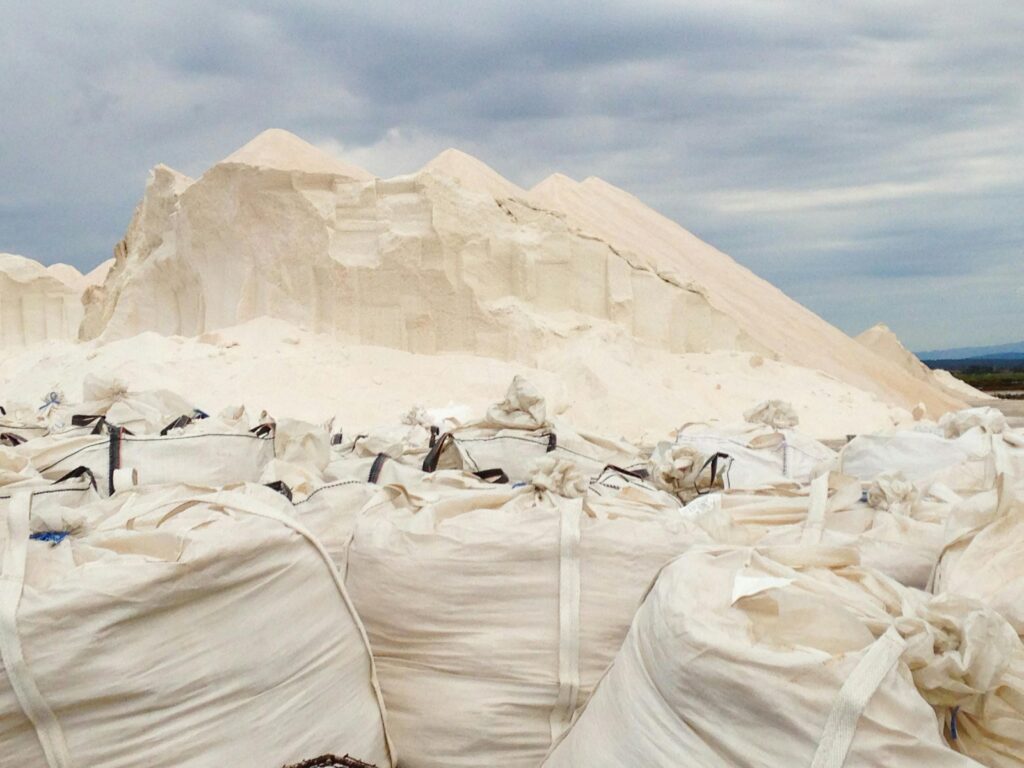 Salt bags and piles at a harvesting site in Ibiza, Spain.